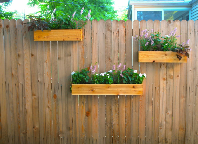 Clôture avec des boîtes pour les plantes